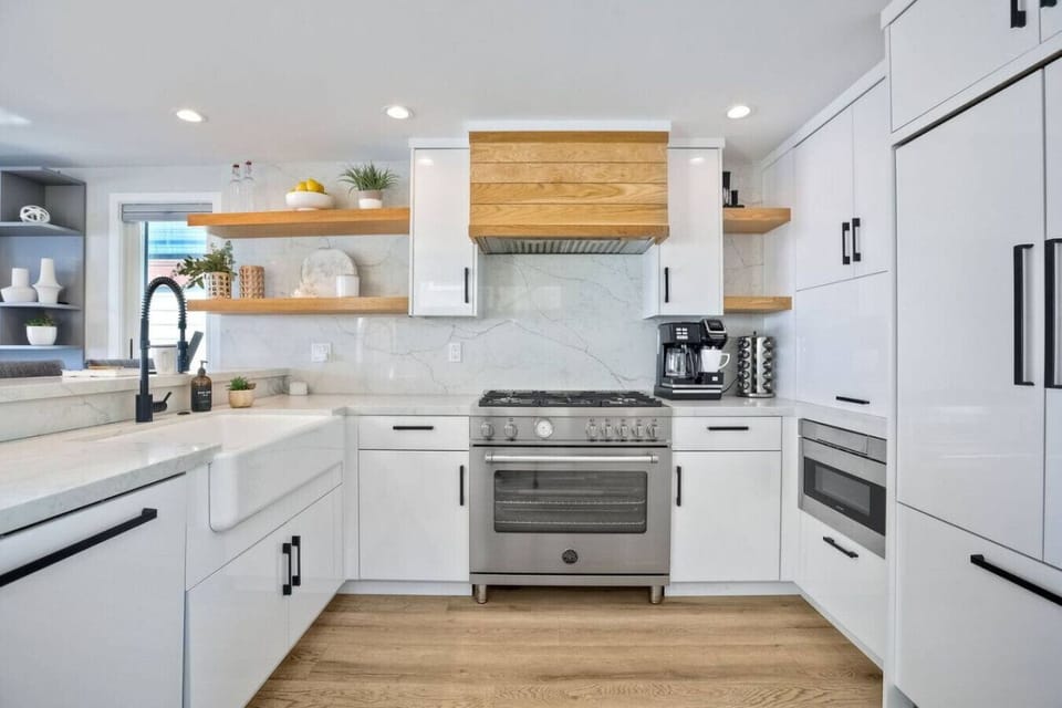 KITCHEN #1 - A bright fully equipped modern kitchen with stainless steel appliances, spacious countertops, and essential cookware for easy meals and entertaining during your Mission Beach San Diego vacation rental stay.