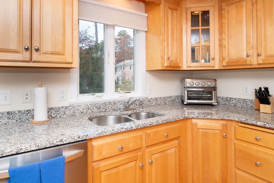 Gaze out the window while prepping meals, with sunlight streaming in to brighten your cooking experience.