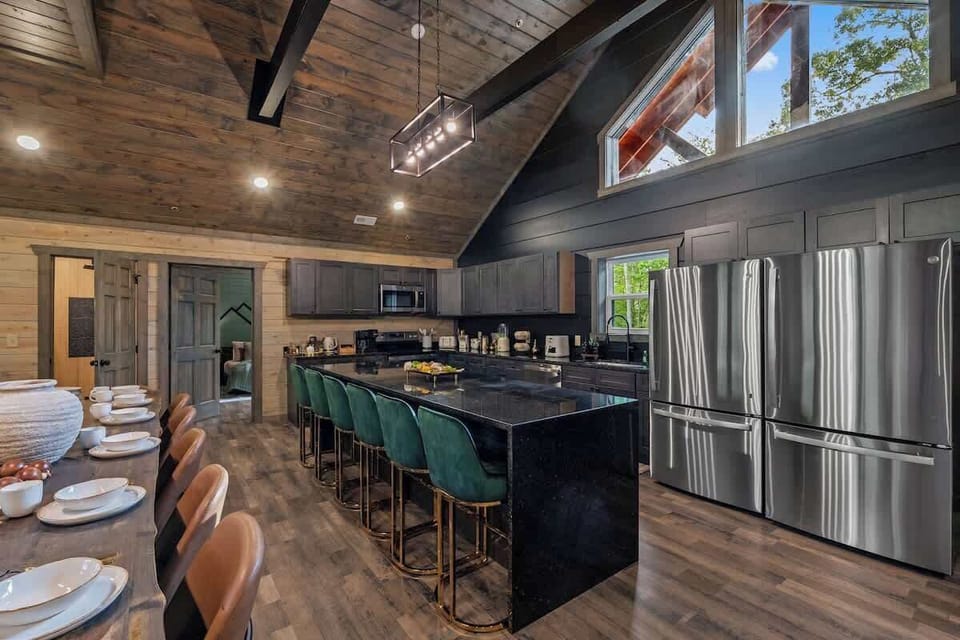 Spacious gourmet kitchen with vaulted wood ceilings and seating for a crowd
