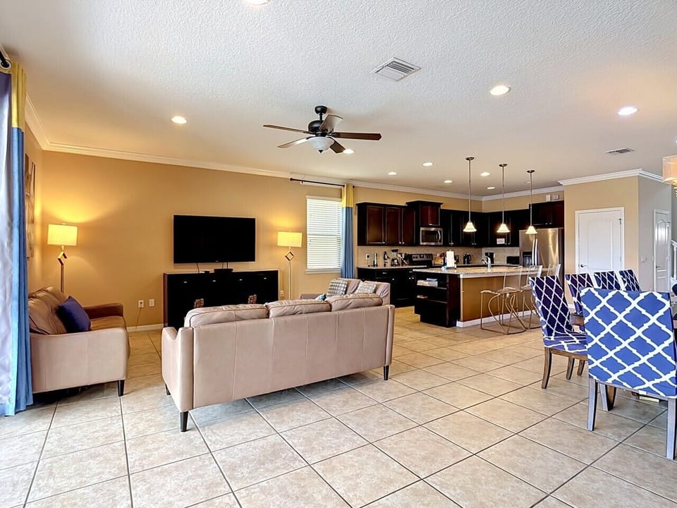 Open-concept living space featuring comfortable seating, dining area, and fully equipped kitchen.