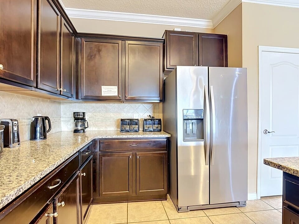 Modern kitchen with stainless steel appliances, granite countertops, and ample cabinet space.