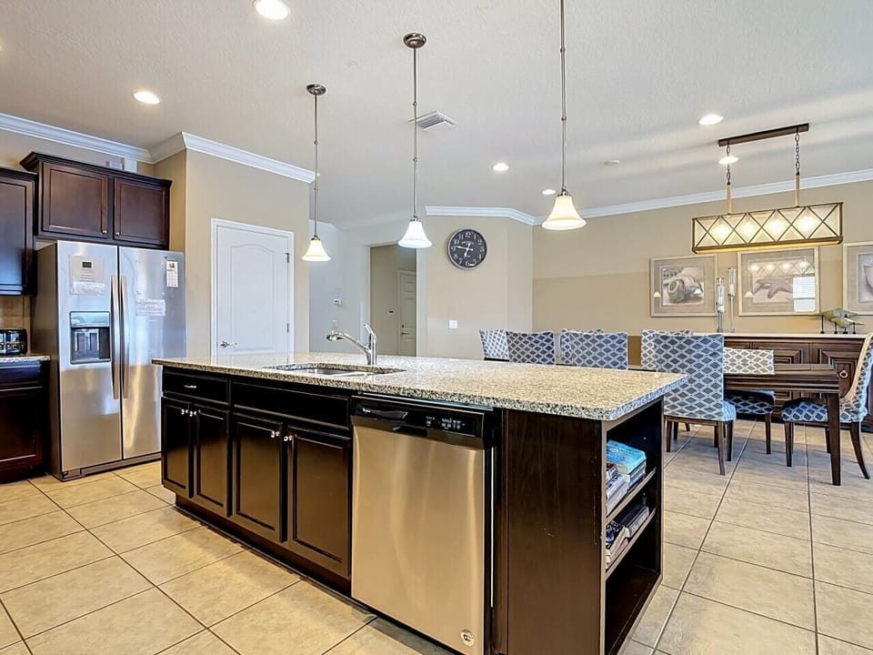 Fully equipped kitchen featuring a large breakfast island, modern finishes, and plenty of space for gathering.
