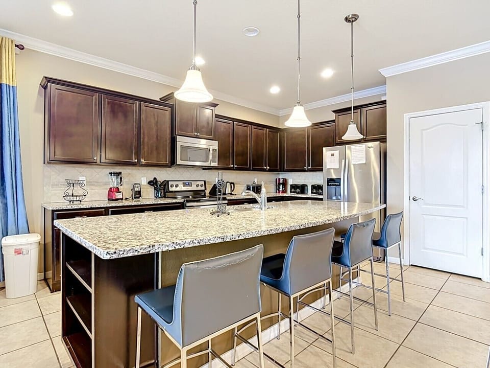 Spacious chef’s kitchen with breakfast bar seating and seamless connection to the living areas.