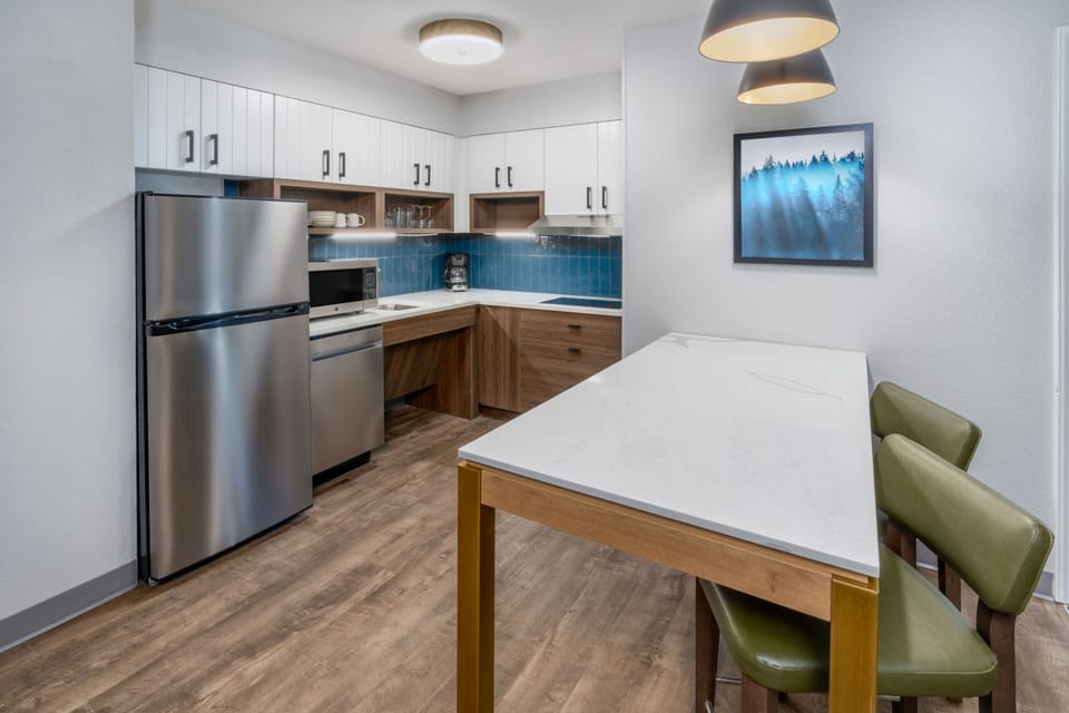 Fully equipped kitchen with modern appliances and dining area.