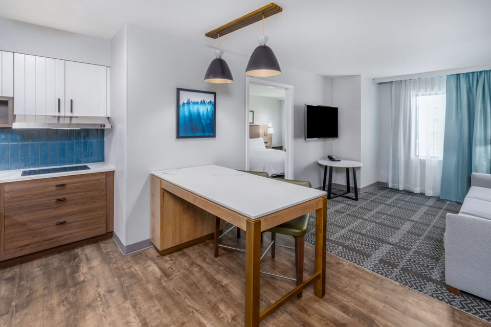 Spacious suite with kitchen, dining area, and comfortable seating.
