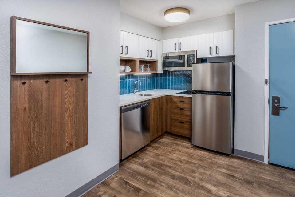 Modern kitchen with stainless steel appliances and warm wooden accents.