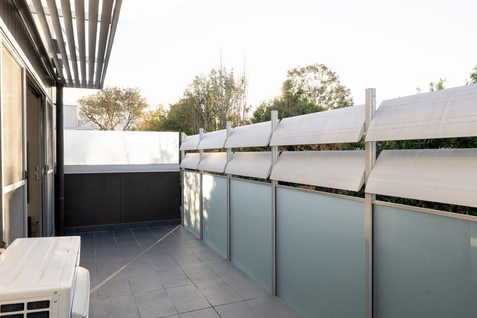 Step out onto your private, sun-drenched balcony to enjoy a breath of fresh air and peaceful treetop views during your morning routine.