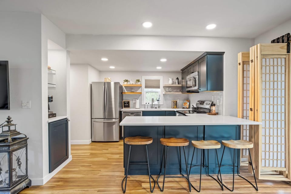 From the navy island to the shoji-style partition beyond, every corner of this kitchen has a detail worth noticing, with seating for four at the counter and the living room just steps away.