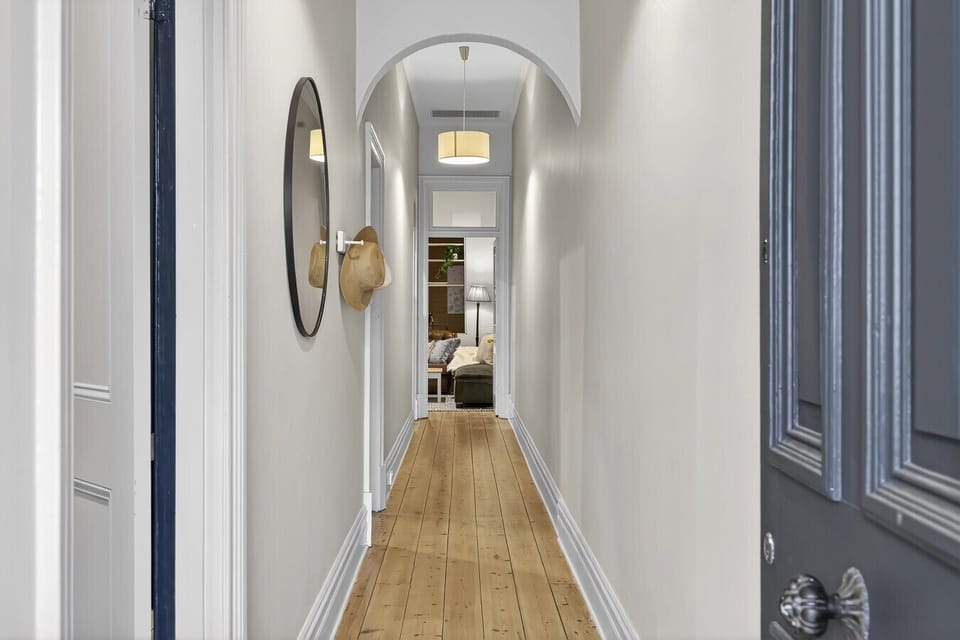Charming hallway with arched ceiling & timber floors