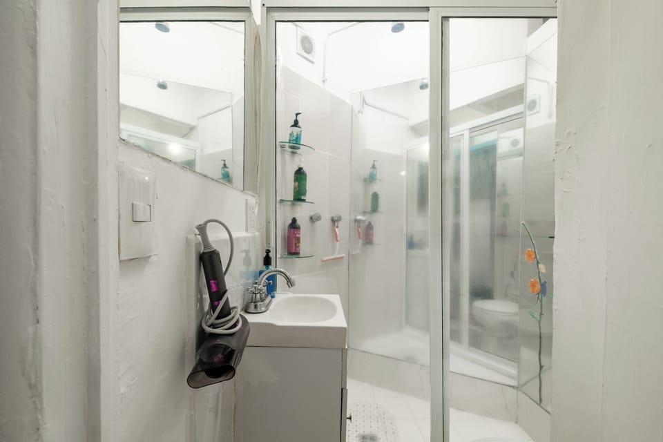 Shower, hair dryer, slippers, towels