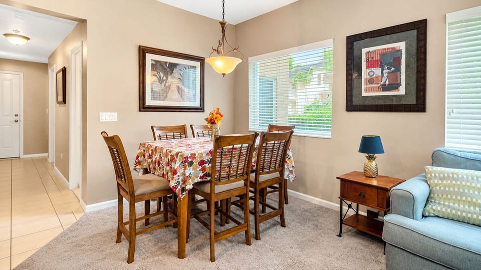 Dining area with a full-size table, natural light, and a comfortable open flow into the living space.