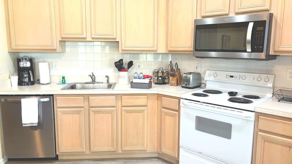 Functional kitchen with full-size appliances, ample cabinet storage, and a clean, convenient layout.