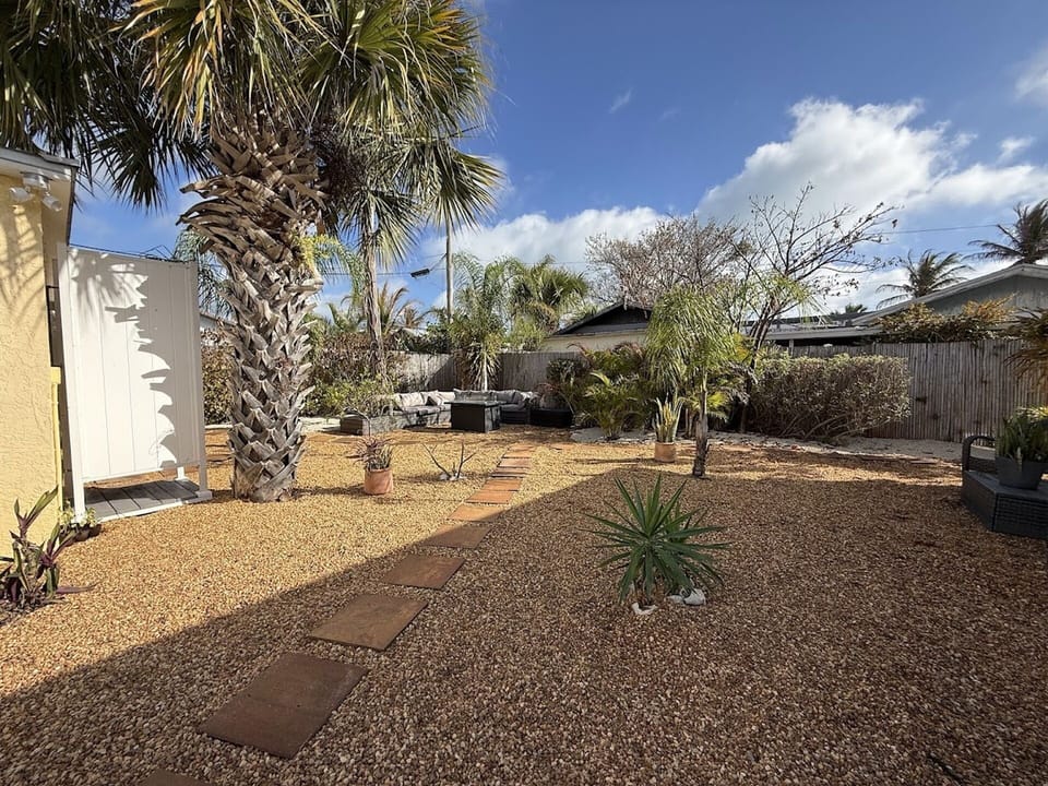 Spacious fenced backyard with low-maintenance landscaping, stepping-stone walkway, and plenty of room to enjoy the outdoors.