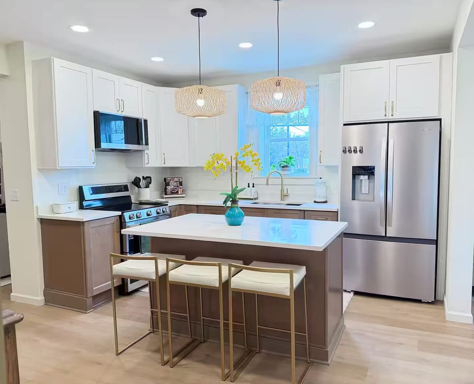 Bright, modern kitchen with a large island, bar seating, and full-size appliance