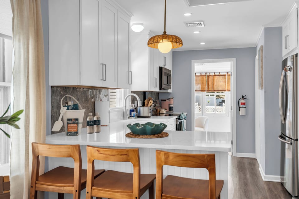 Bright modern kitchen with peninsula seating and stainless appliances