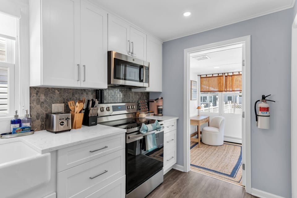 Bright modern kitchen with stainless appliances and sunny adjoining nook
