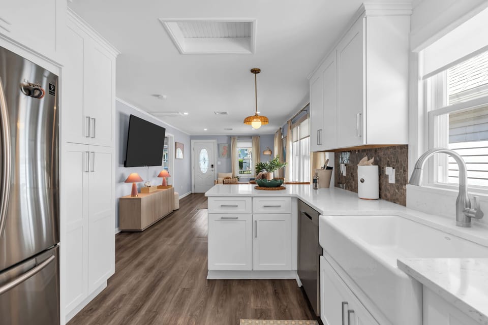 Bright open-concept kitchen with farmhouse sink and modern finishes