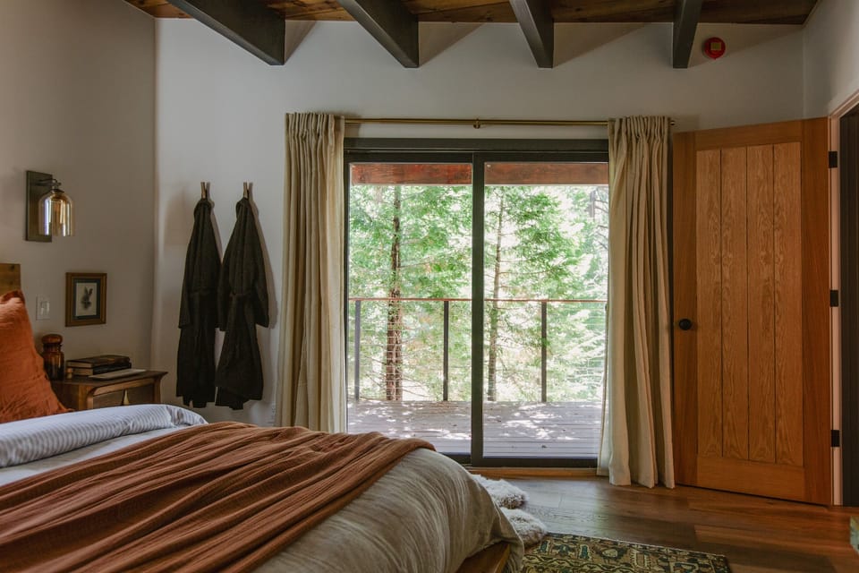 Throw open the curtains to flood the room with natural light, or enjoy direct access to the deck to soak in the forest views. 