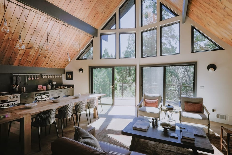 The great room with vaulted pine wood ceilings is flooded with natural light. 