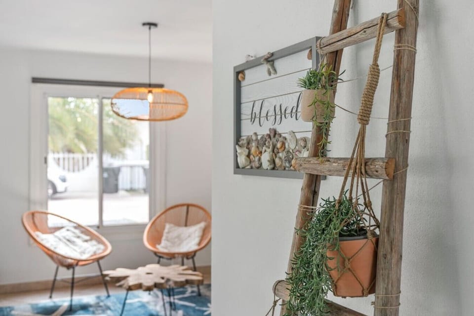 Bright and comfortable living area with stylish seating, tropical touches, and plenty of space to relax after a day at the beach.