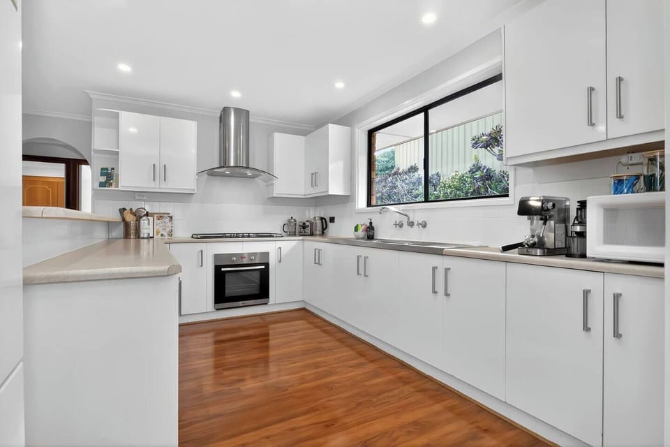 Prepare everything from leisurely breakfasts to family dinners in this bright, contemporary kitchen, where generous bench space, an oven, stovetop, microwave, refrigerator and espresso machine make cooking and entertaining feel effortless.