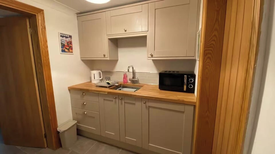 Kitchenette equipped with fridge, separate freezer, microwave, airfyer, toaster, kettle and Nespresso machine.