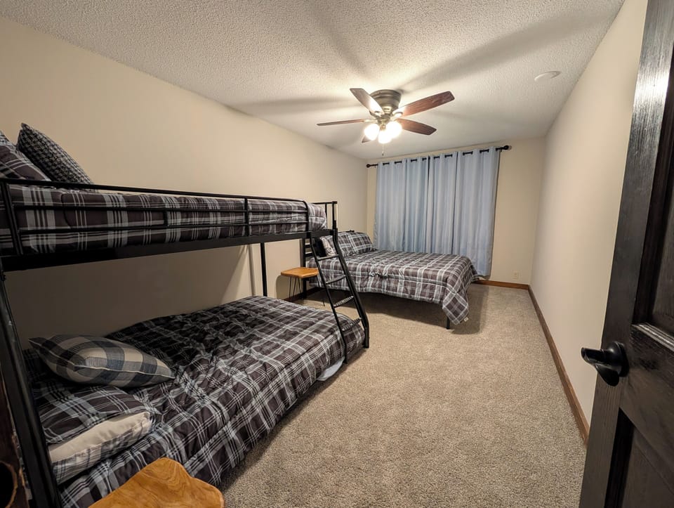 Bedroom with queen bed and bunk bed.