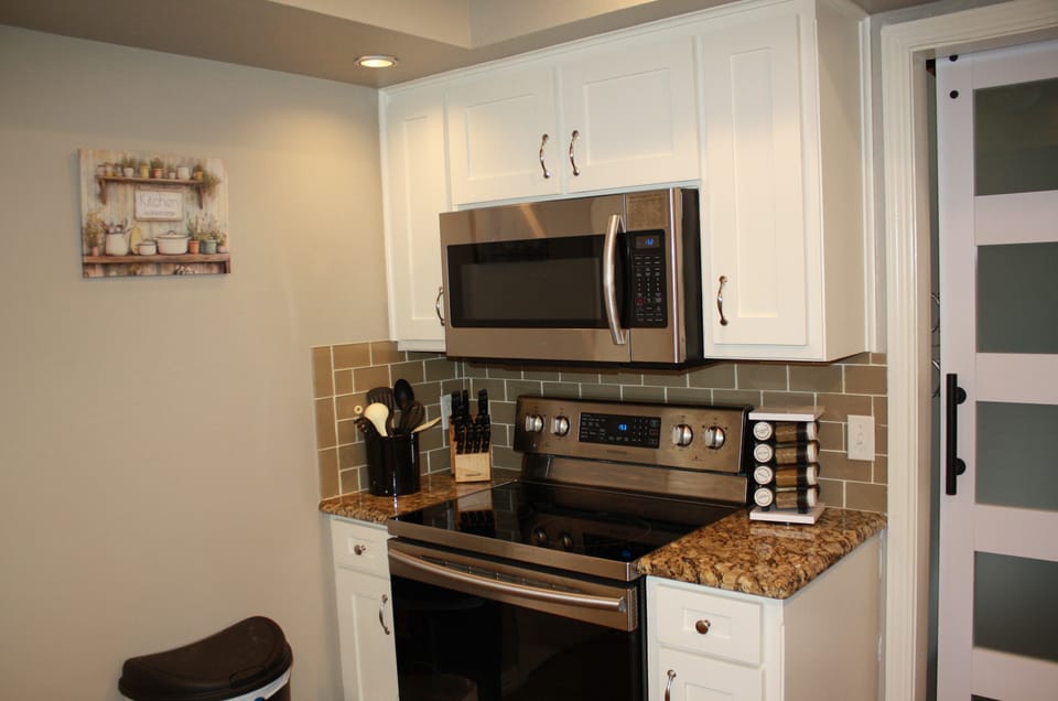 Microwave above cooktop in kitchen