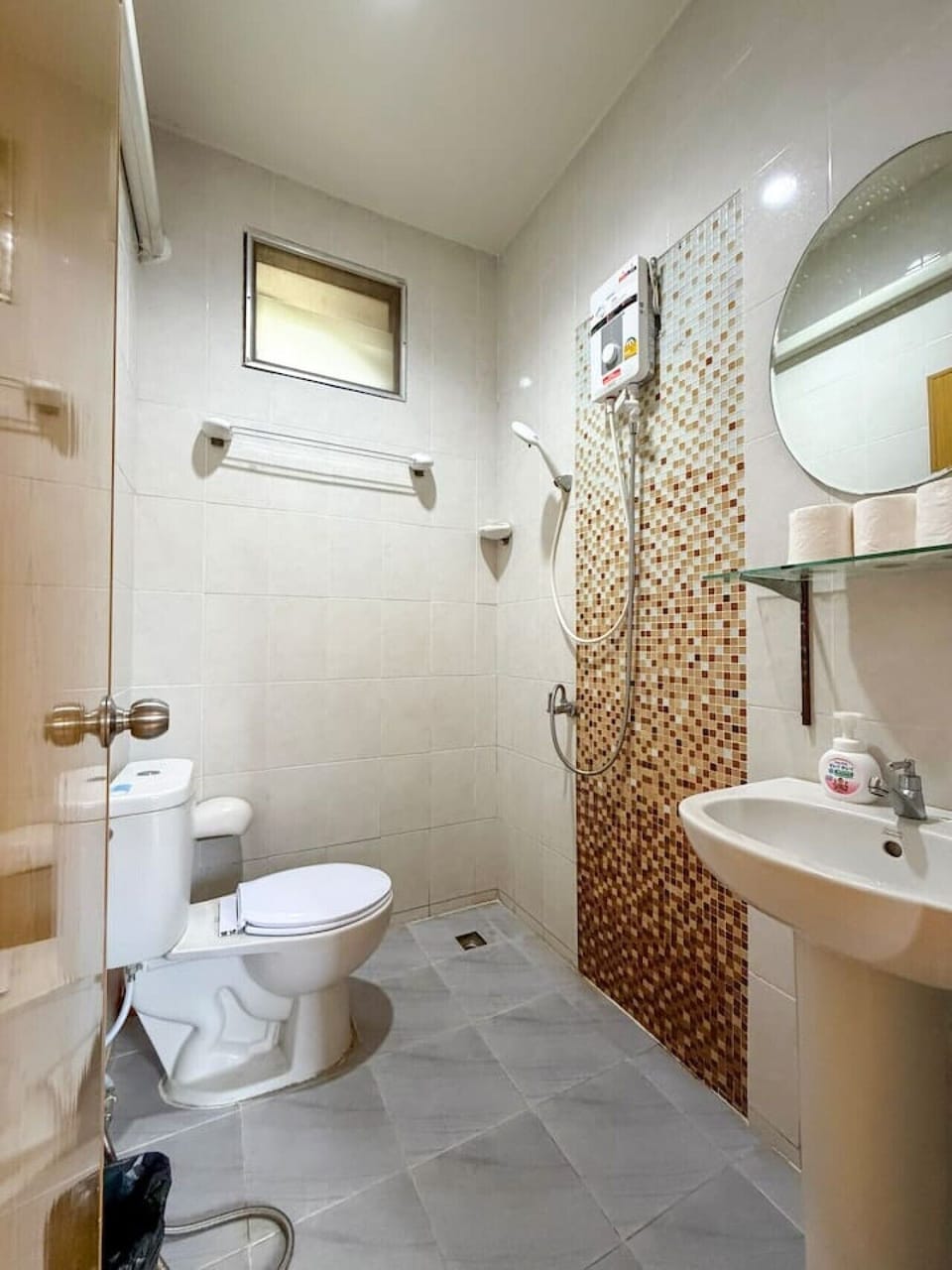 Modern bathroom with hot shower and essential amenities.