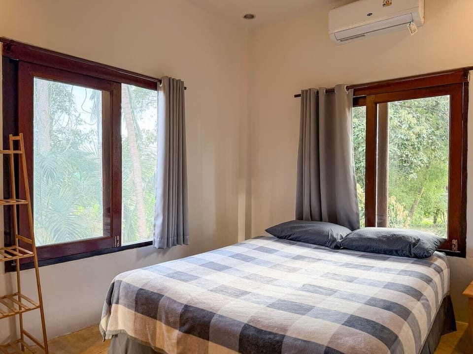 Comfortable bedroom with natural light for a peaceful night`s sleep.