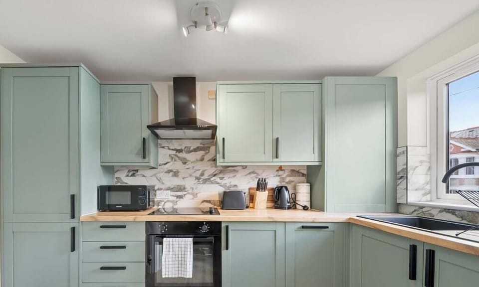 Fully equipped kitchen with modern appliances, cookware, and dining essentials. Perfect for preparing home-cooked meals, quick breakfasts, or enjoying a coffee before exploring the area.