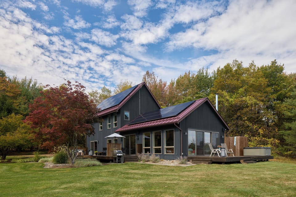Looking towards the main house and hot tub deck. Oversized windows and sliding glass doors create beautiful views on the interior and fill the space with light.