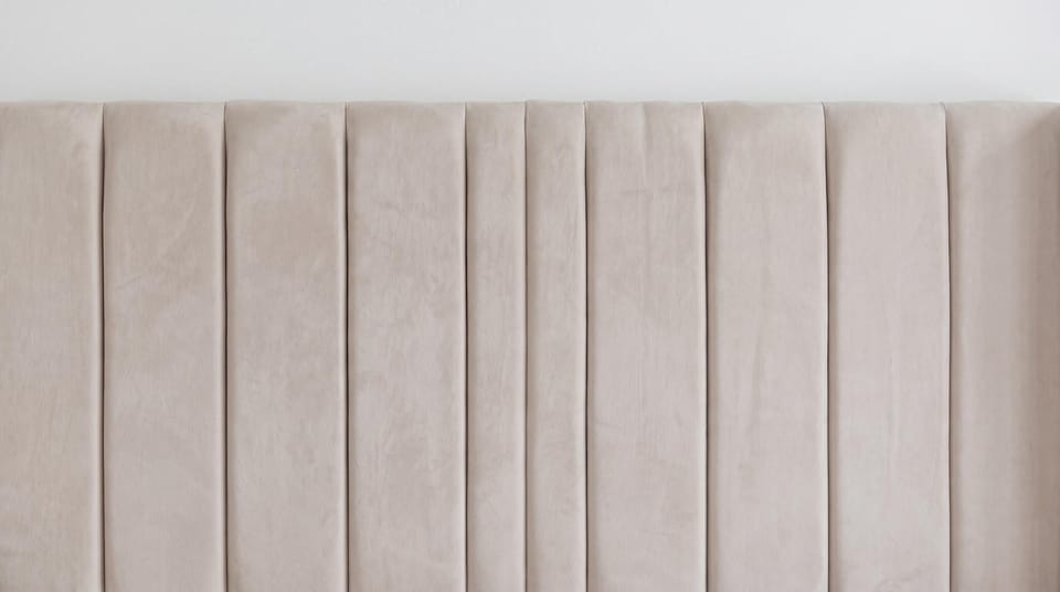 Luxuriate in the plush bedding with elegant headboard for ultimate comfort.
