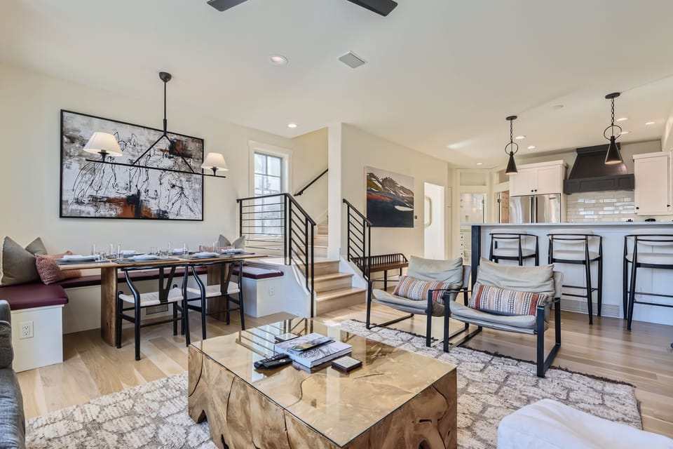 Open-concept living and dining area with designer finishes, cozy seating, and a spacious kitchen made for gathering together.