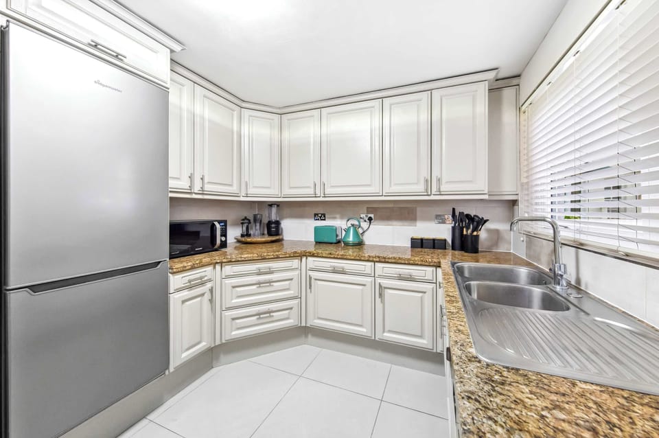 Fully equipped kitchen with a spacious refrigerator to keep your groceries and drinks fresh.