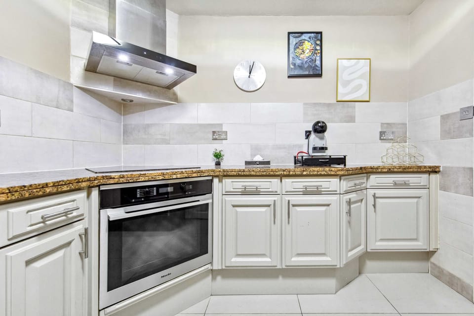Cook your favorite dishes with ease in a kitchen equipped with a sleek cooker hood.