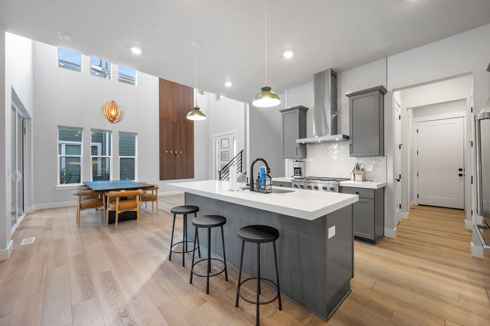 A culinary dream. This gourmet kitchen boasts top-of-the-line stainless steel appliances, a spacious waterfall island with seating for four, and custom cabinetry.