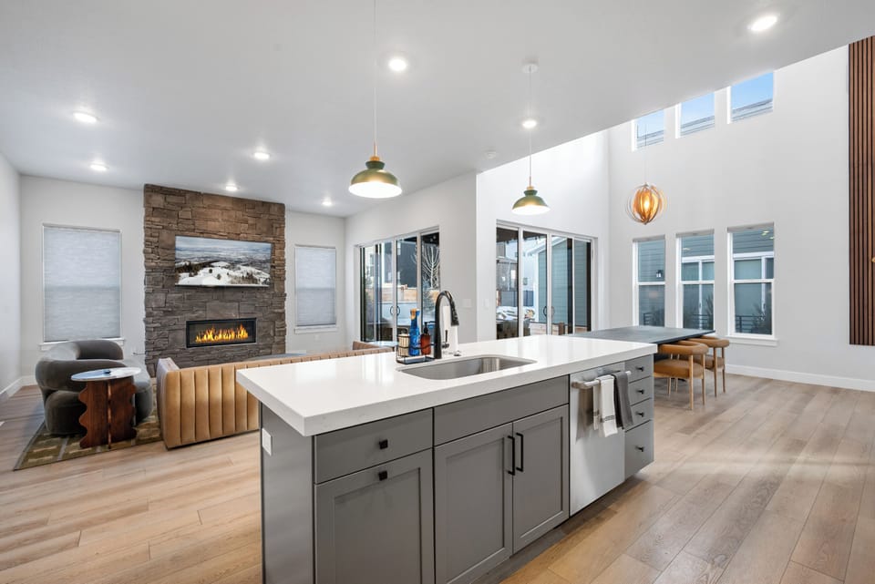 Professional-grade kitchen featuring sleek grey cabinetry and a waterfall-edge center island.