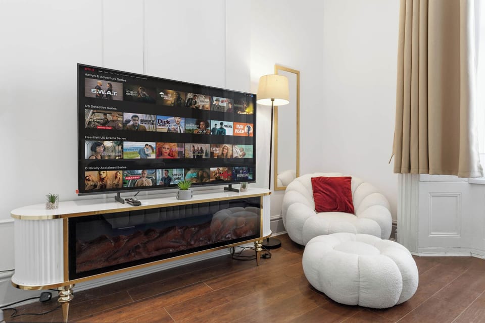 Settle in for a cozy night with entertainment and the inviting ambiance of an electric fireplace.