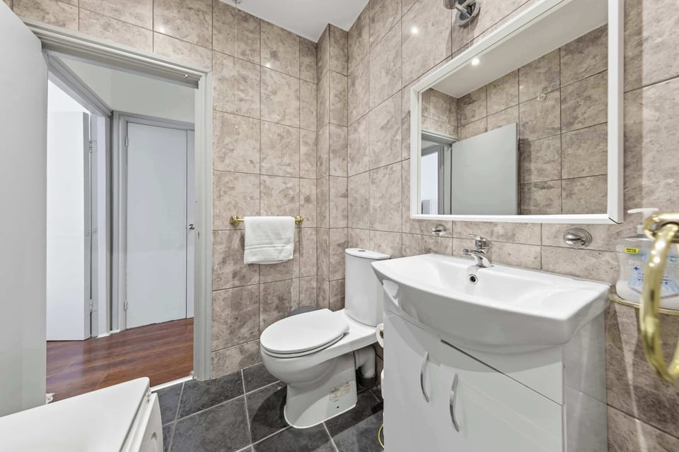Get ready effortlessly in a clean and comfortable bathroom with a stylish mirror, perfect for your daily routine.