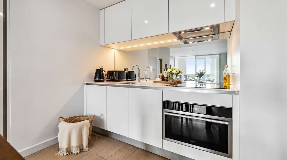 Sleek kitchen with top-of-the-line appliances for culinary delights.