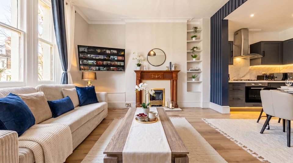 Relax by the elegant fireplace in a bright, inviting living room