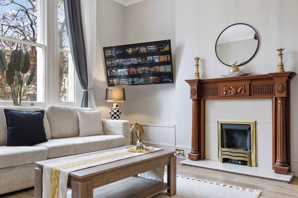 Bright living area with large windows, a feature fireplace, and a coffee table for relaxing with your favorite drink.