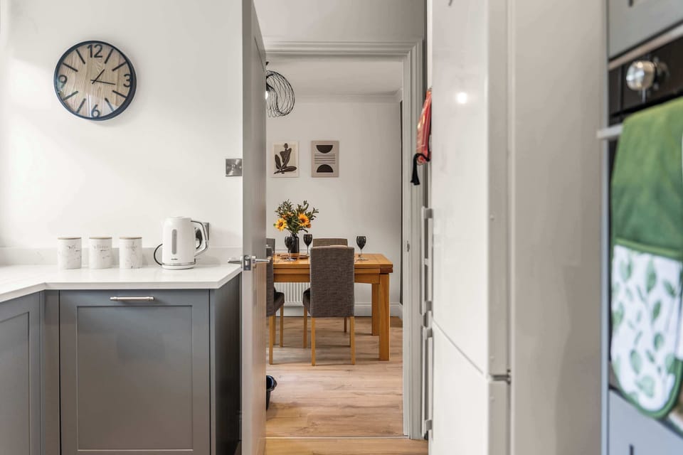 The modern kitchen is fully equipped with everything you could need to cook a meal away from home, featuring a dishwasher, oven, washing machine, toaster, kettle, microwave and coffee machine.