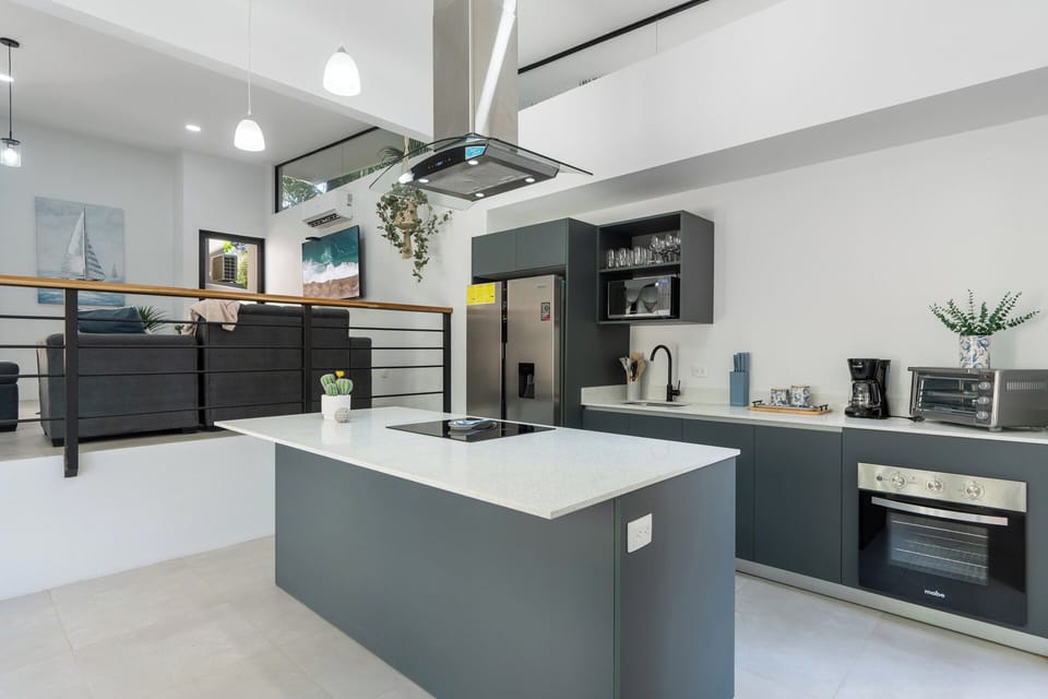 Another angle of the open-concept luxury kitchen, fully stocked with everything you need. Ideal for a cozy family dinner or hosting a private chef in Tamarindo, Costa Rica.