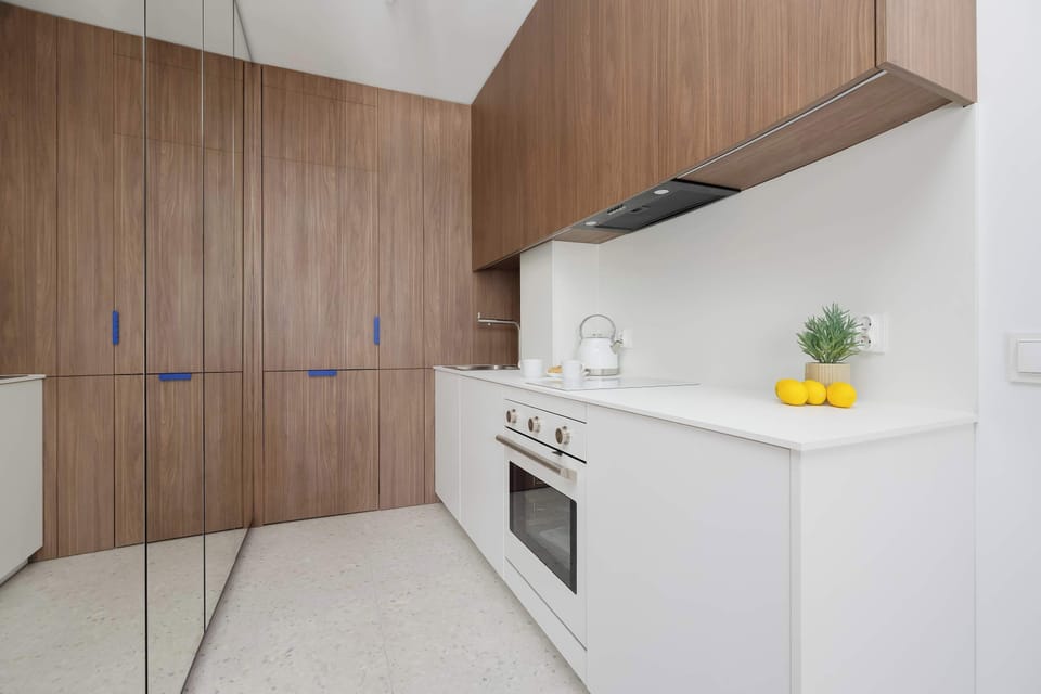 Fully equipped kitchenette with built-in appliances, ample storage, and a modern design.