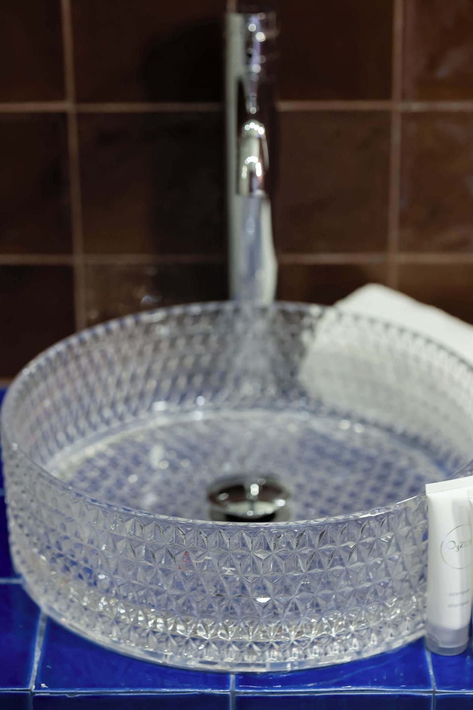 Elegant glass vessel sink paired with a contemporary faucet and refined bathroom details.