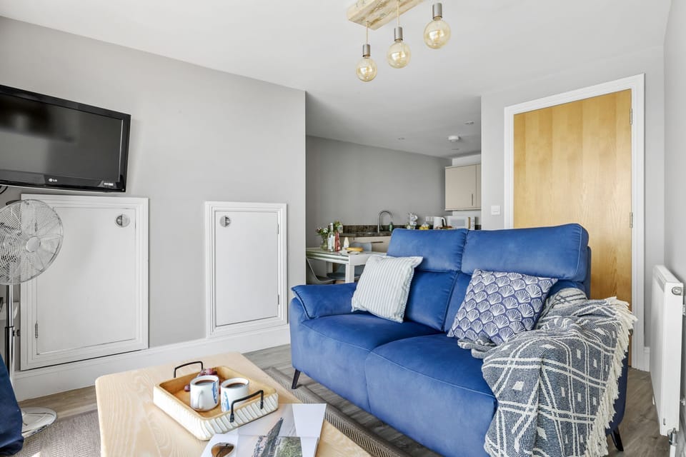 Living room leading to kitchen with cooking facilities - Marina View Suite