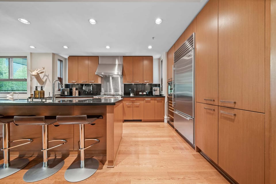 Kitchen - Chef-grade Wolf and Sub-Zero appliances, breakfast bar seating — fully equipped for cooking in