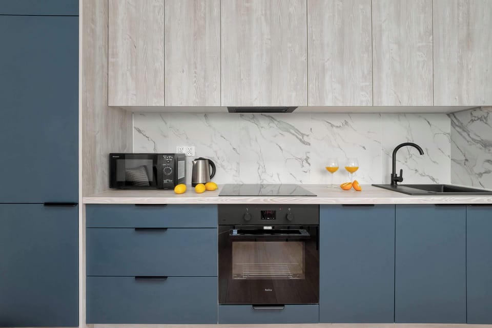 Fully equipped contemporary kitchen with modern appliances and stylish cabinetry.